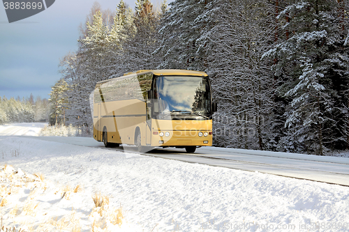 Image of Yellow Bus on Winter Road
