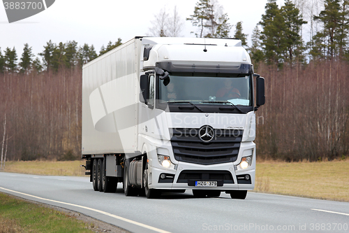 Image of White Mercedes-Benz Actros Semi Truck on Spring Road