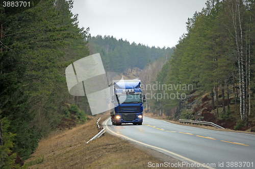 Image of Blue Semi Truck on Forest Highway