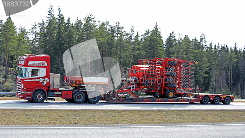 Image of Scania Semi Hauls Agricultural Machinery in High Speed