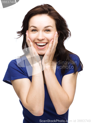 Image of Woman is holding her face in astonishment