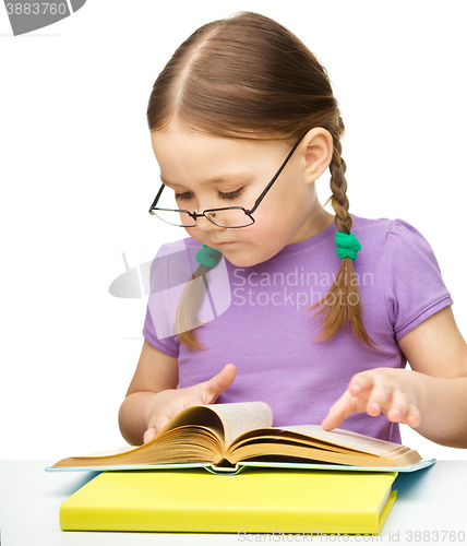 Image of Little girl is reading a book