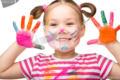 Image of Portrait of a cute girl playing with paints