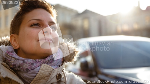 Image of Young woman looking towards sun