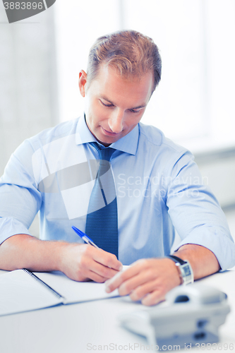 Image of handsome businessman working in the office