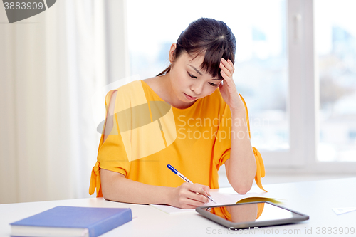 Image of tired asian woman student with tablet pc at home