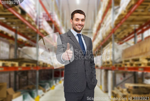 Image of happy man at warehouse showing thumbs up gesture