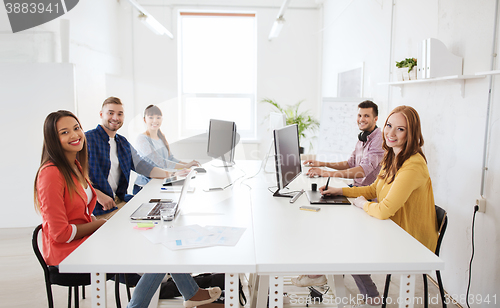 Image of creative team with computers, blueprint at office