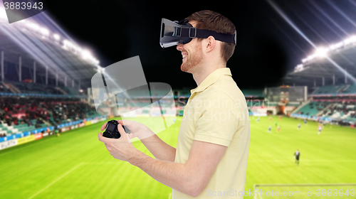 Image of man in virtual reality headset over football field