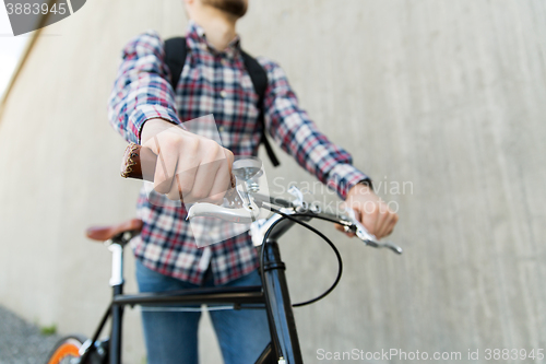 Image of hipster man with fixed gear bike and backpack