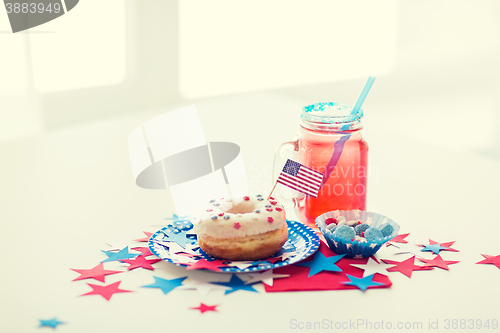 Image of donut with juice and candies on independence day