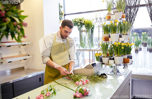 Image of florist man making bunch at flower shop