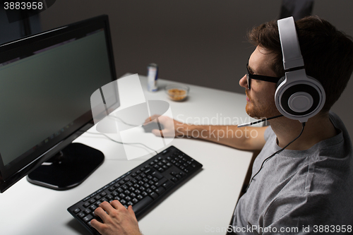 Image of close up of man playing computer video game