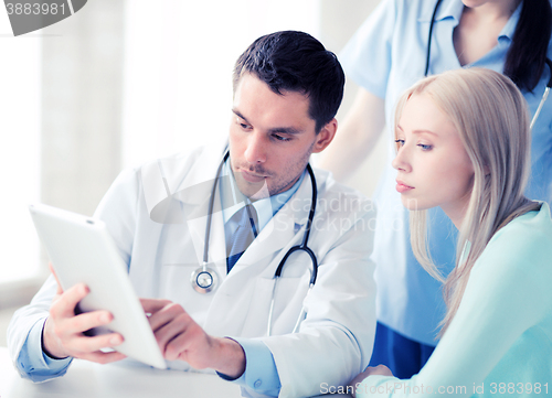 Image of doctor and nurse with patient in hospital