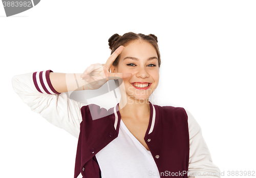 Image of happy smiling teenage girl showing peace sign