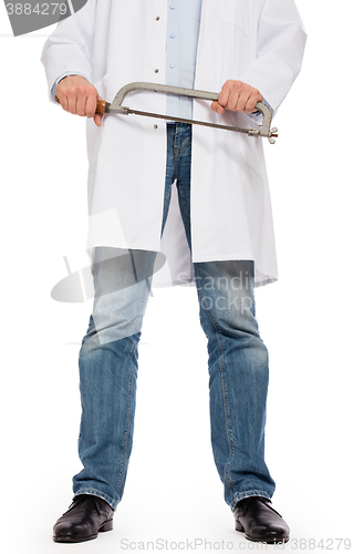 Image of Crazy doctor is holding a big saw in his hands