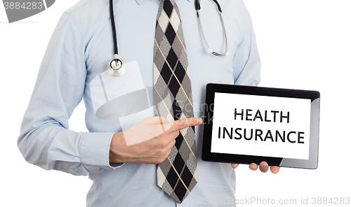 Image of Doctor holding tablet - Health insurance