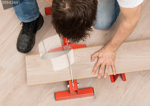 Image of Red tool for cutting laminate