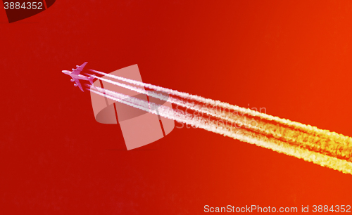 Image of Plane in blue sky - Bright red and orange sky