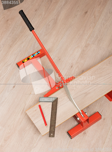 Image of Red tool for cutting laminate