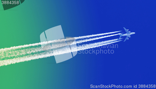 Image of Plane in blue sky - Bright blue and green sky