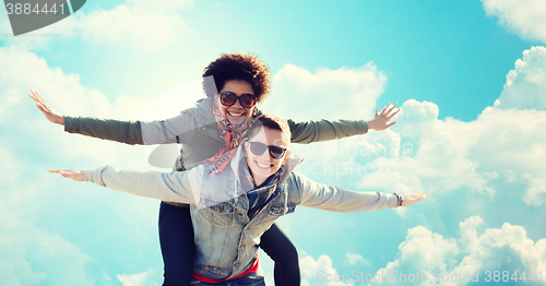 Image of happy teenage couple in shades having fun outdoors