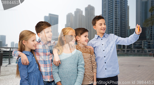 Image of happy children talking selfie by smartphone