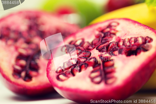 Image of close up of ripe pomegranate and other fruits