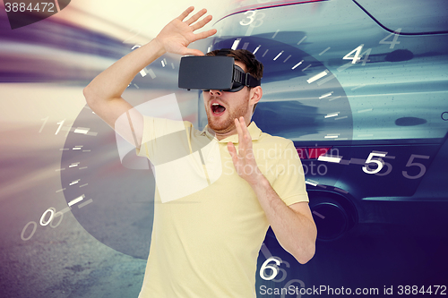 Image of man in virtual reality headset and car racing game