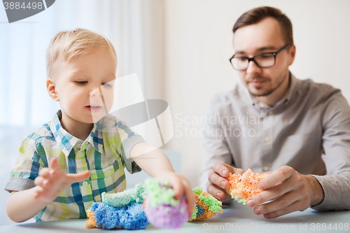 Image of father and son playing with ball clay at home