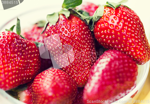 Image of close up of ripe red strawberries over white