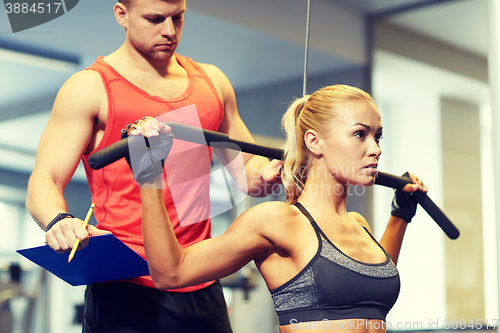 Image of man and woman flexing muscles on gym machine