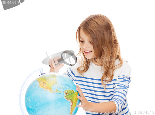 Image of student girl looking at globe with magnifier