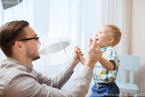 Image of father with son playing and having fun at home