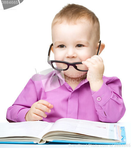 Image of Little child play with book