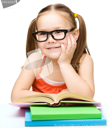 Image of Little girl is reading a book