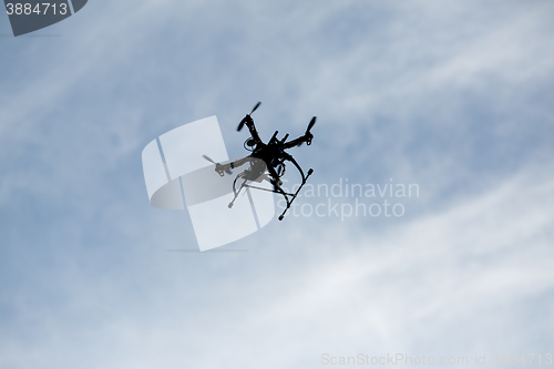 Image of flying drone with camera on the sky