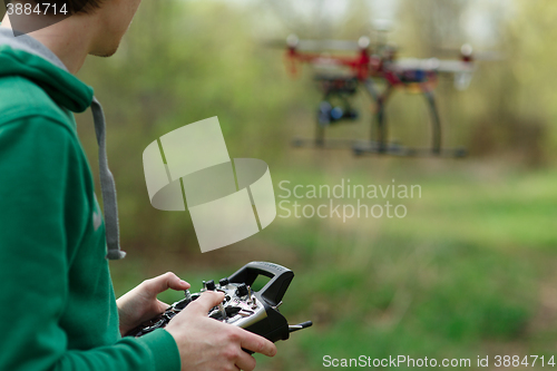 Image of Man controling a drone.