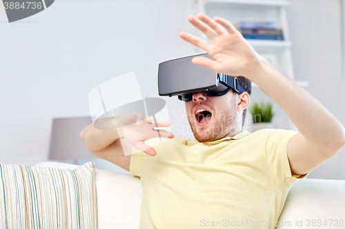 Image of young man in virtual reality headset or 3d glasses