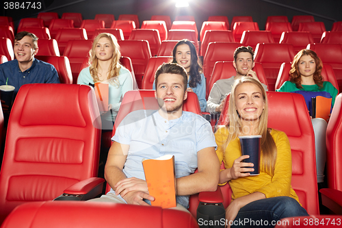 Image of happy friends watching movie in theater