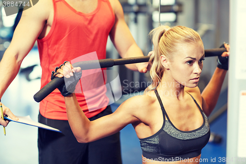 Image of man and woman flexing muscles on gym machine