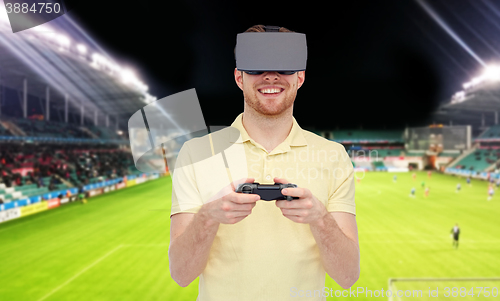 Image of man in virtual reality headset over football field