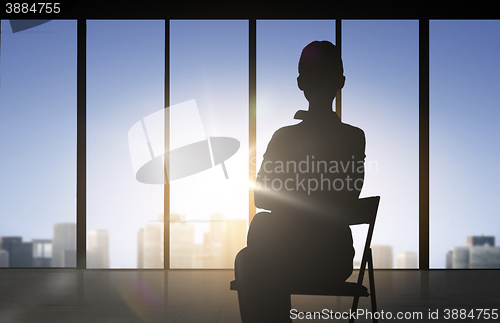 Image of silhouette of business woman sitting on chair