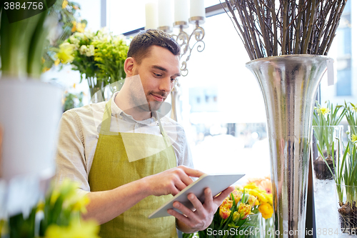 Image of man with tablet pc computer at flower shop