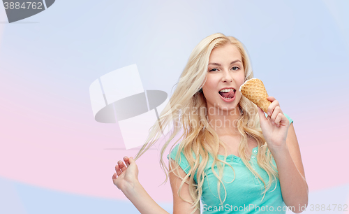 Image of happy young woman in sunglasses eating ice cream