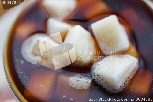 Image of close up of lump sugar in coffee cup or tea