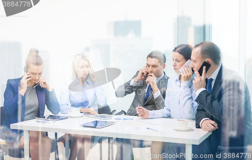 Image of business team with smartphones having conversation