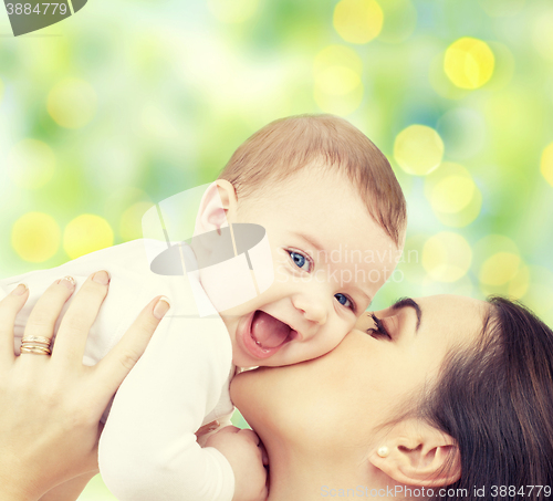 Image of happy mother with baby over green background