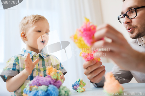 Image of father and son playing with ball clay at home