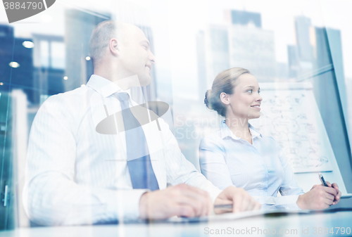 Image of smiling business people meeting in office